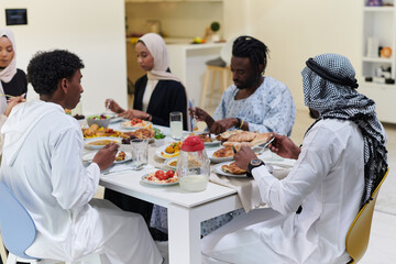 A traditional and diverse Muslim family comes together to share a delicious iftar meal during the sacred month of Ramadan, embodying the essence of familial joy, cultural richness, and spiritual unity