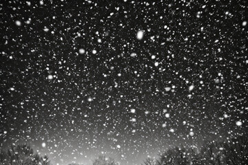 Mesmerizing snowy night scene with trees looming in the foreground, evoking a sense of enchantment...