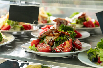 Showcase with salads in the dining room or cafeteria - obrazy, fototapety, plakaty