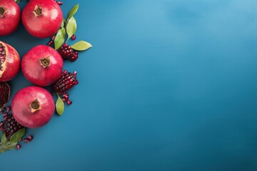 Copy space top view of ripe pomegranates on blue background