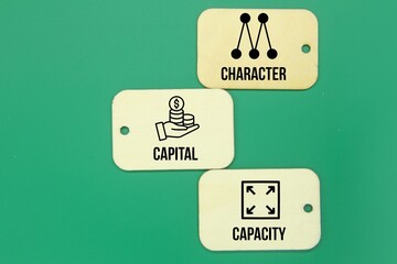wooden tag with 3 C's in economy ie Character, capital (or collateral), and capacity