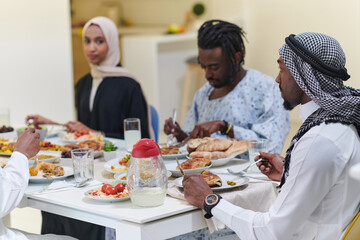 A traditional and diverse Muslim family comes together to share a delicious iftar meal during the sacred month of Ramadan, embodying the essence of familial joy, cultural richness, and spiritual unity