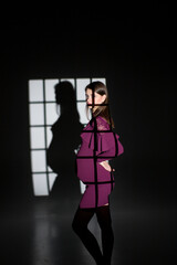 pregnant woman posing in studio, pregnancy woman in window