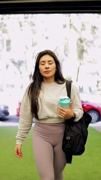 Mexican woman with sports clothing arriving at the gym to train with her shaker in her hand