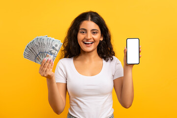 Cheerful young indian lady showing phone and money