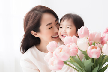 Smiling Asian female and child with tulips, mother day concept