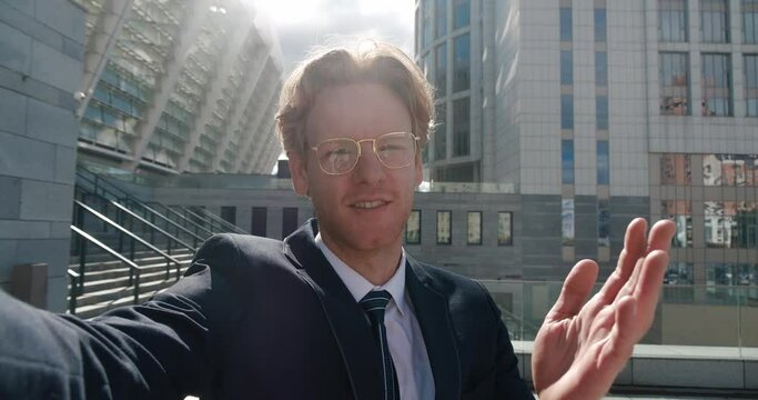 Blogger gives online tour of business center where works as manager. Online tour takes place video on street. Online blogger answers questions from subscribers about work manager in business center.