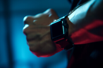 Detailed view of a smartwatch displaying the time duration of a plank exercise, focus on the watch and forearm muscles, indirect lighting to highlight the technology and precision in tracking fitness 