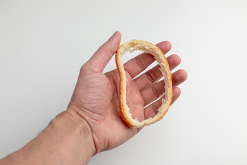 A Hand Holding a Hollowed Bread Slice