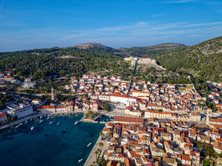 Naklejka na ściany i meble Aerial view of Hvar city in the Island of Hvar in Croatia. Famous for having an incredible nightlife scene, alongside its renowned historic town center and natural landscapes.