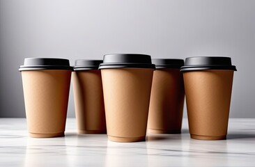 Eco friendly paper craft cups for coffee with black lid on the white wooden background. Zero waste, plastic free concept. Sustainable lifestyle. Front view.