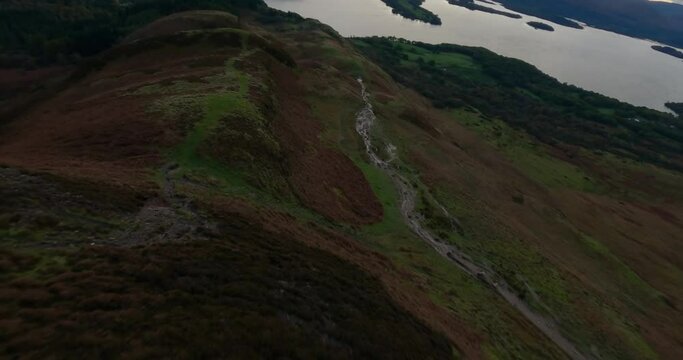 Aerial shot of Loch Lomond while flying over Conic Hill, Highlands, Scotland.
