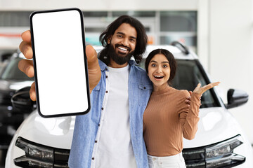 Young indian couple in casual standing by brand new car