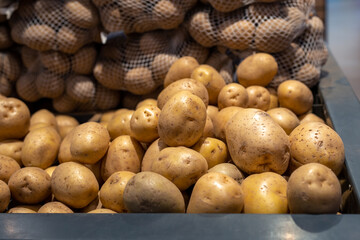 Closeup of fresh organic harvest potatoes on the supermarket shelf