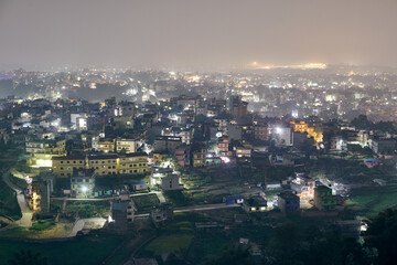 Fototapeta na wymiar Aerial night Kathmandu cityscape with lot of low rise buildings with dim lights of nighttime city, Kathmandu twilight dreamscape with tranquil ambiance and serenity of night
