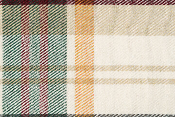 texture of a traditional scotch check in beige, yellow and green colors close-up. tartan for shirts and warm clothes. Image for your design