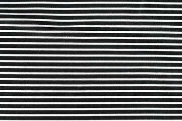 close-up texture of black and white striped silk fabric at an angle. Tailoring concept. Image for...