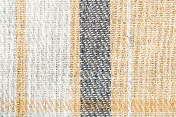 Texture of beige and gray tartan fabric close-up. Concept of materials and fabrics for clothing and textiles. Image for your design