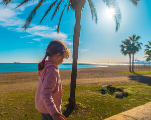 Beautiful Spanish girl walking on the beach of Malagueta in Malaga, Spain