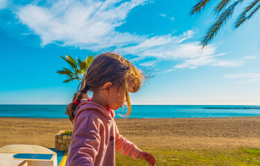 Beautiful Spanish girl walking on the beach of Malagueta in Malaga, Spain
