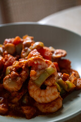 Shrimp with tomatoes on a baking plate, close-up