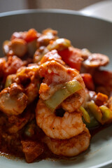 Shrimp with tomatoes on a baking plate, close-up