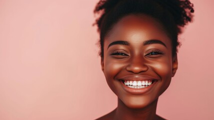 Radiant Young Woman With a Bright Smile Against a Soft Pink Background