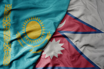 big waving national colorful flag of nepal and national flag of kazakhstan.
