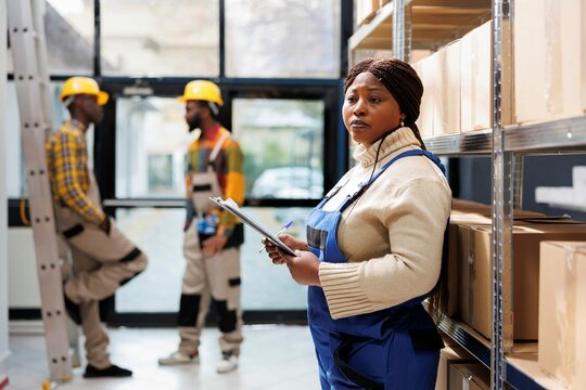 African American Warehouse Woman Operator Holding Clipboard