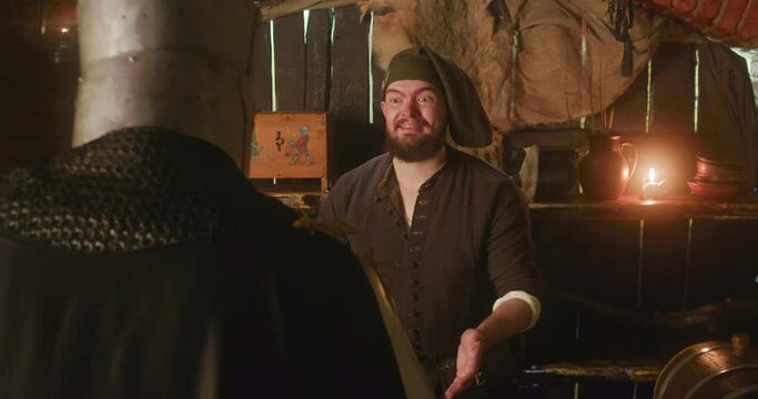 Smiling bearded keeper and knight drinking beer in tavern. Funny dwarf restaurant owner tries to please honorable guest with alcohol at inn. Dark medieval fantasy