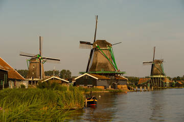 Windmills in the beautiful village of Zaanse Schans in Netherlands at sunset