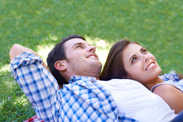 Couple, smile and relax on grass for connection, bonding and love in park outdoors. Happy, man and woman in summer for holiday, vacation or date for healthy relationship in field with closeup