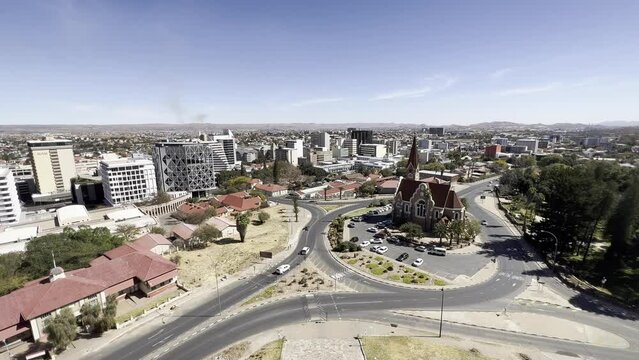 Windhoek, Namibia - August 14, 2022: Christ Church, together with the skyline of Windhoek, shot from the Independence Memorial Museum.