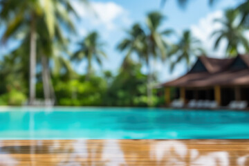 Tropical blurred background with empty table top near swimming pool on sunny day. Copy space.