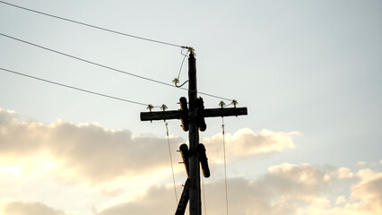 wooden power line at sunset