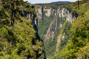 Waterfall, forest and cliffs in Itaimbezinho Canyon