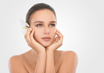 Thinking, flower and woman with beauty, skincare and dermatology on white studio background. Person, model and girl with natural cosmetics and shine with luxury and clear skin with glow and aesthetic