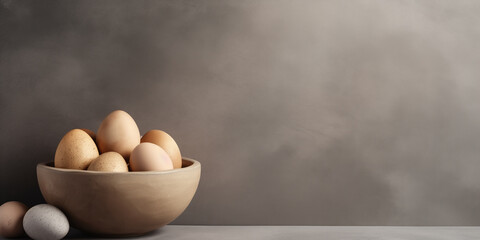 Organic chicken eggs in a bowl on grey background. Easter food theme. - Powered by Adobe