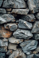 A pile of rocks arranged neatly in a stack formation. This image can be used to depict stability, balance, and organization. It can also be used to represent nature, outdoors, and natural formations