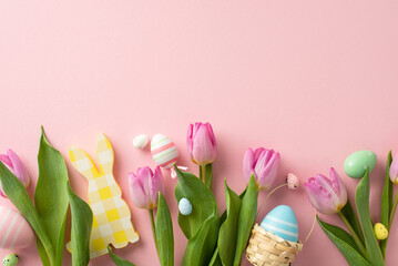 Festive arrangement with vibrant eggs, an endearing bunny, tiny basket, and tulips. Top view on a...