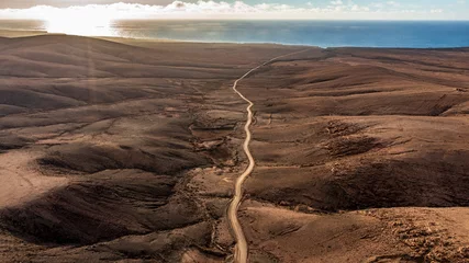 Photo sur Plexiglas les îles Canaries Aerial view from above of the panorama in the north coast sland of Fuerteventura, Canary Islands. Spain. A small, unfamiliar dirt road takes motorists to the ocean