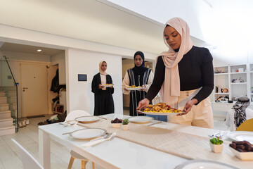 Group of young Arab women come together to lovingly prepare an iftar table during the sacred Muslim month of Ramadan, embodying the essence of communal unity, cultural tradition, and joyous