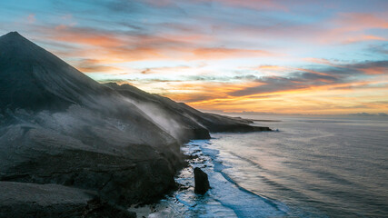 Aerial view of Cofete beach at the sunset. Above view of the large beach of Cofete and monolith...
