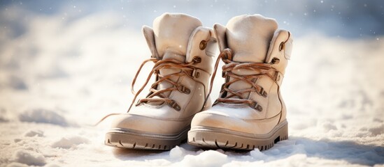 Winter boots with laces on white snow close up. Creative Banner. Copyspace image - obrazy, fototapety, plakaty