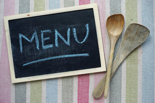 Menu written n a chalkboard on a colored plaid