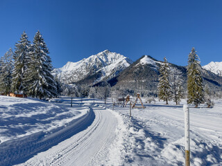 Fototapeta na wymiar Winter hiking trail in a snow-covered landscape in Pertisau at Lake Achensee.