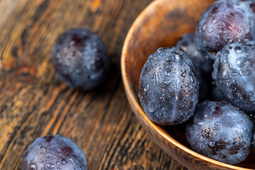 Wet purple plum on the table, fresh harvest