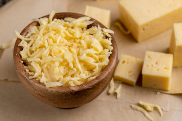 grated yellow semi-hard cheese with holes