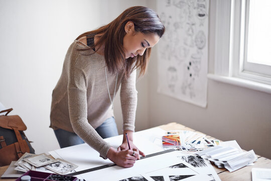 Woman, photography and paper for creative project with images for art portfolio, planning or professional. Female person, pencil and ruler in studio with picture prints or magazine, proposal or hobby