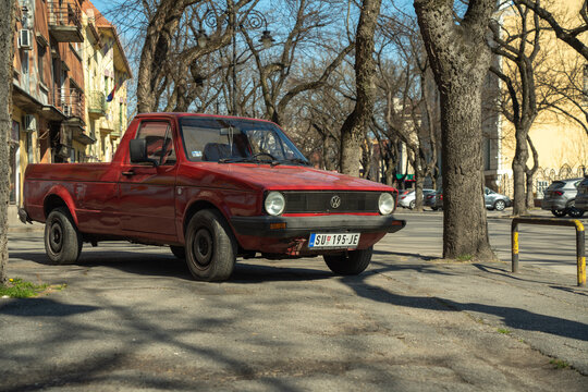 Parked wine red color Volkswagen Caddy (1st generation based on Golf 1 platform also known in USA as Rabbit Pickup) is still using as every day commerce transport. 18.03.2023 Subotica, Serbia.